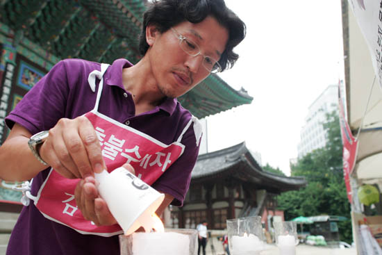 대형초에 불 붙이는 김광일
